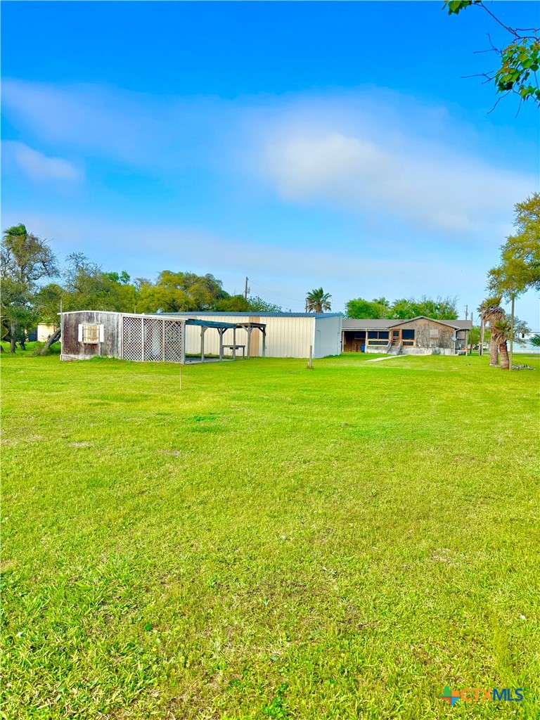 503 16th Street Port O'Connor, TX 77982 - Photo 48 of 48 a view of a swimming pool with a yard and trees