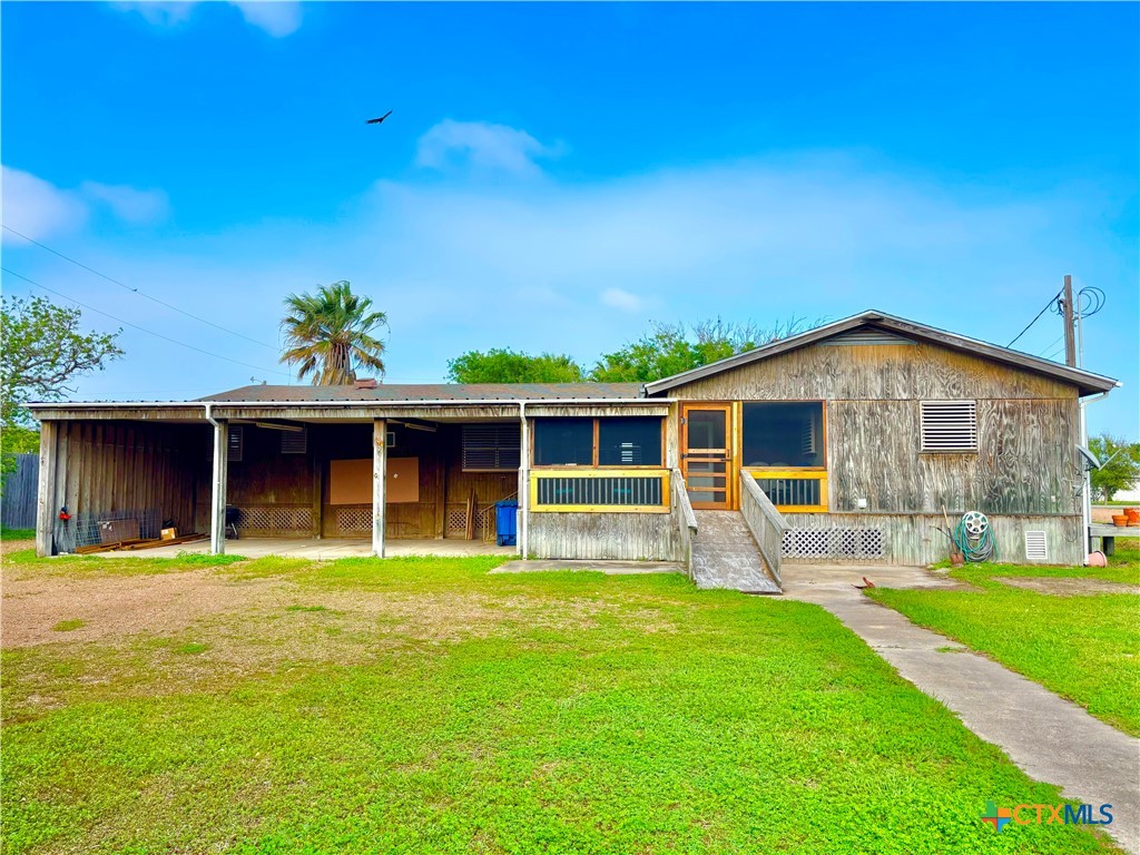 503 16th Street Port O'Connor, TX 77982 - Photo 7 of 48 a front view of house with a garden and swimming pool