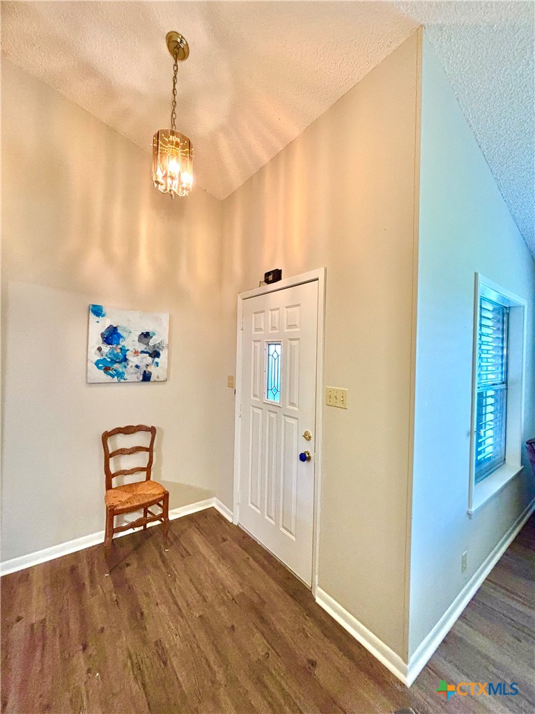 503 16th Street Port O'Connor, TX 77982 - Photo 10 of 48 a view of a hallway with wooden floor and a chandelier