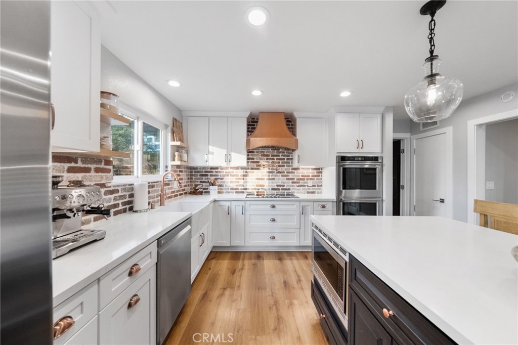 40221 Paseo Sereno Temecula, CA 92591 - Photo 14 of 45 a kitchen with stainless steel appliances a sink a stove a refrigerator and cabinets