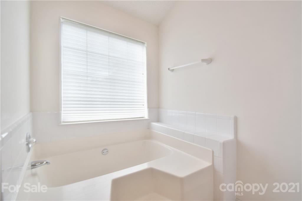 3407 Brownes Ferry Road Charlotte, NC 28269 - Photo 13 of 24 a white bath tub sitting next to a window