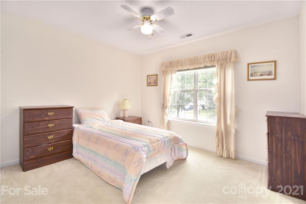 3407 Brownes Ferry Road Charlotte, NC 28269 - Photo 14 of 24 a bedroom with a bed and a window