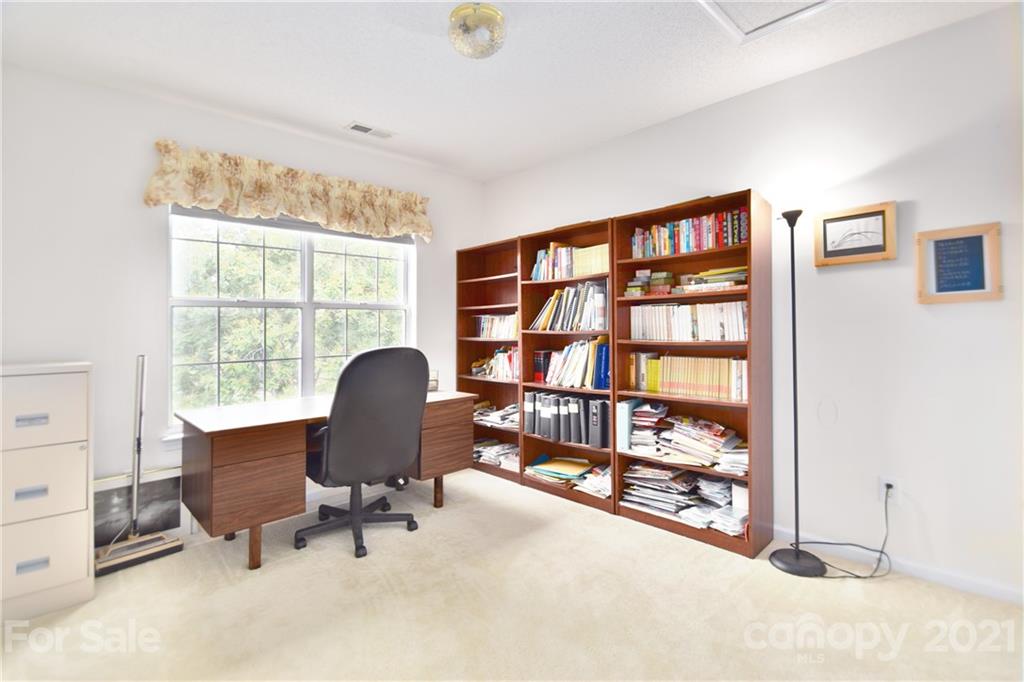 3407 Brownes Ferry Road Charlotte, NC 28269 - Photo 16 of 24 a workspace with a bookshelf