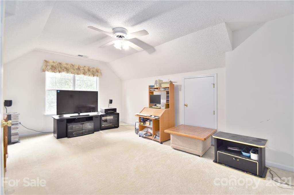 3407 Brownes Ferry Road Charlotte, NC 28269 - Photo 17 of 24 a living room with furniture and a flat screen tv