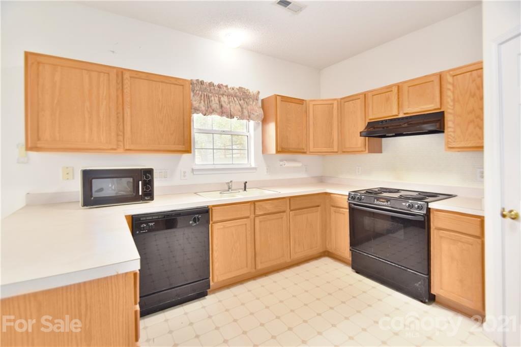 3407 Brownes Ferry Road Charlotte, NC 28269 - Photo 6 of 24 a kitchen with stainless steel appliances granite countertop a sink stove and refrigerator