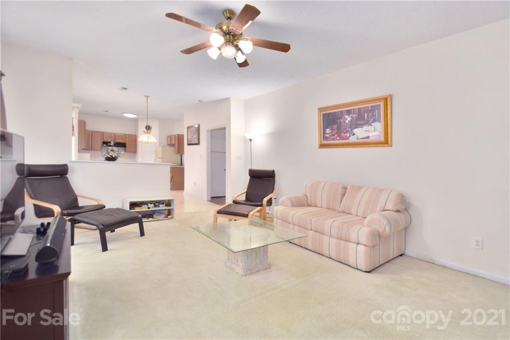 3407 Brownes Ferry Road Charlotte, NC 28269 - Photo 10 of 24 a living room with couches and kitchen view with wooden floor