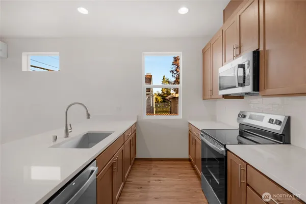 a kitchen with a sink cabinets and stainless steel appliances