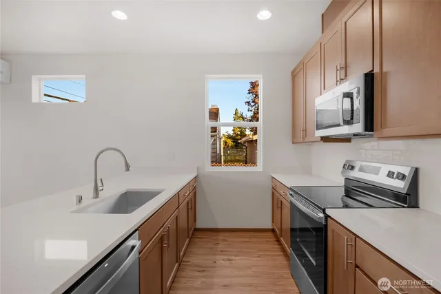 a kitchen with a sink cabinets and stainless steel appliances
