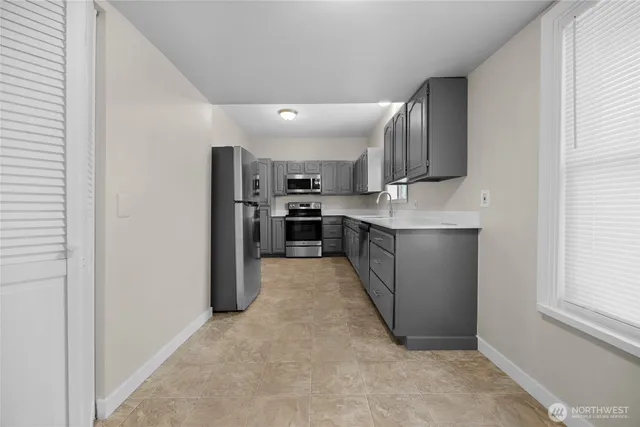a kitchen with stainless steel appliances granite countertop a refrigerator and a stove top oven
