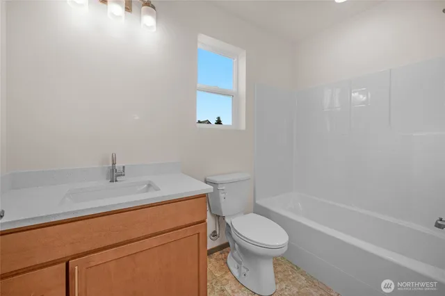 a bath room with a toilet a sink and a bath tub