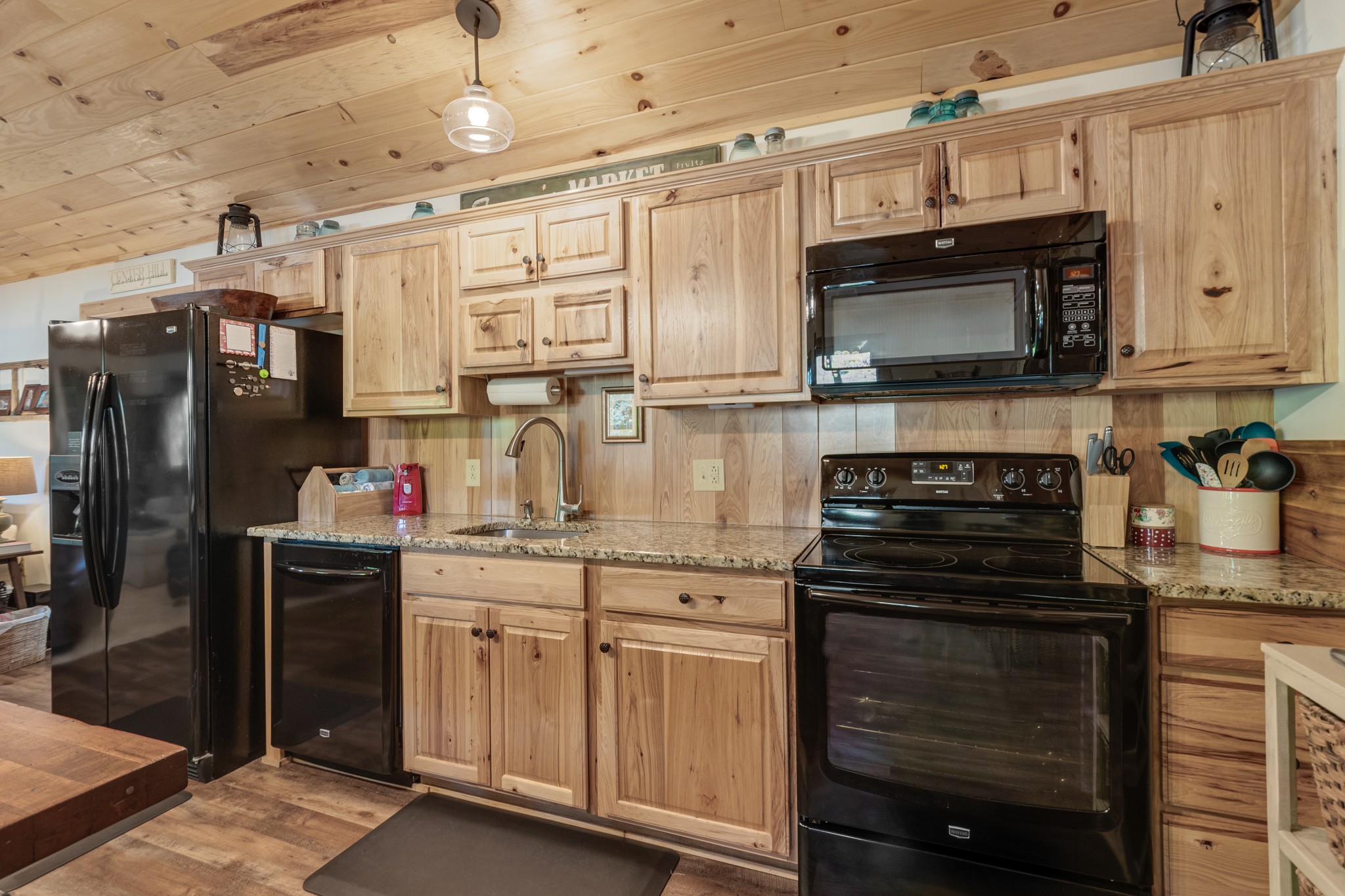 6089 Norman Thomas Road Silver Point, TN 38582 - Photo 16 of 37 a kitchen with stainless steel appliances granite countertop a stove and a refrigerator