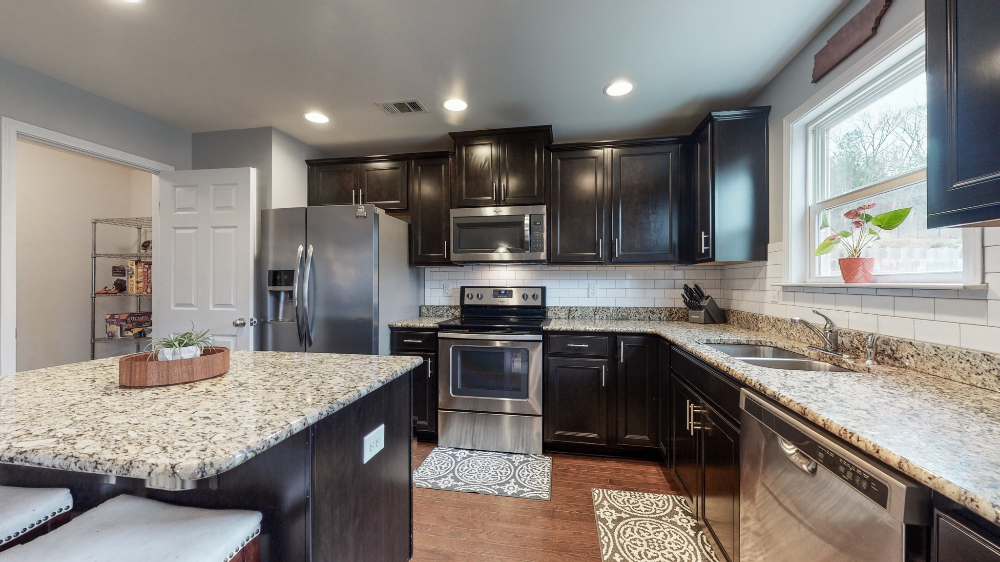 1412 Old Stone Road Lebanon, TN 37087 - Photo 8 of 18 a kitchen with stainless steel appliances granite countertop sink stove refrigerator and cabinets