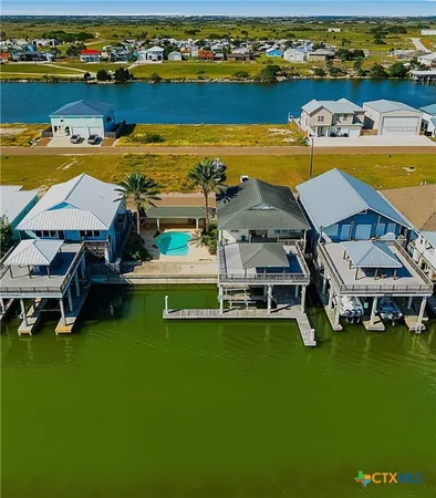 an aerial view of a house with a swimming pool yard and outdoor seating