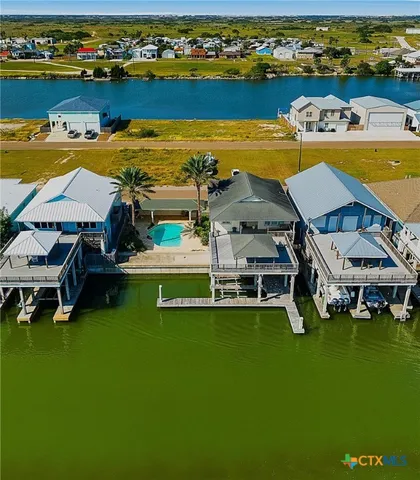 an aerial view of a house with a swimming pool yard and outdoor seating