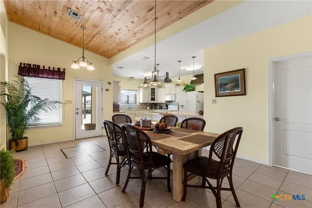 a view of a dining room with furniture and chandelier