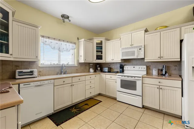 a kitchen with appliances cabinets and a sink