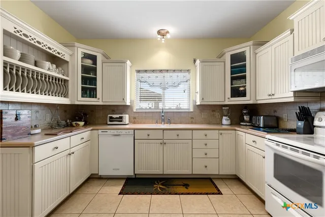 a kitchen with a cabinets window and appliances