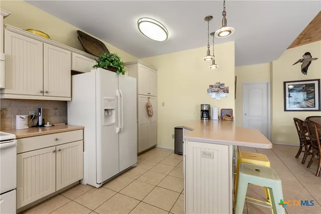 a kitchen with cabinets and wooden floor