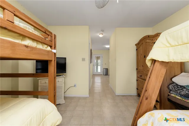 a bedroom with a bed and a television