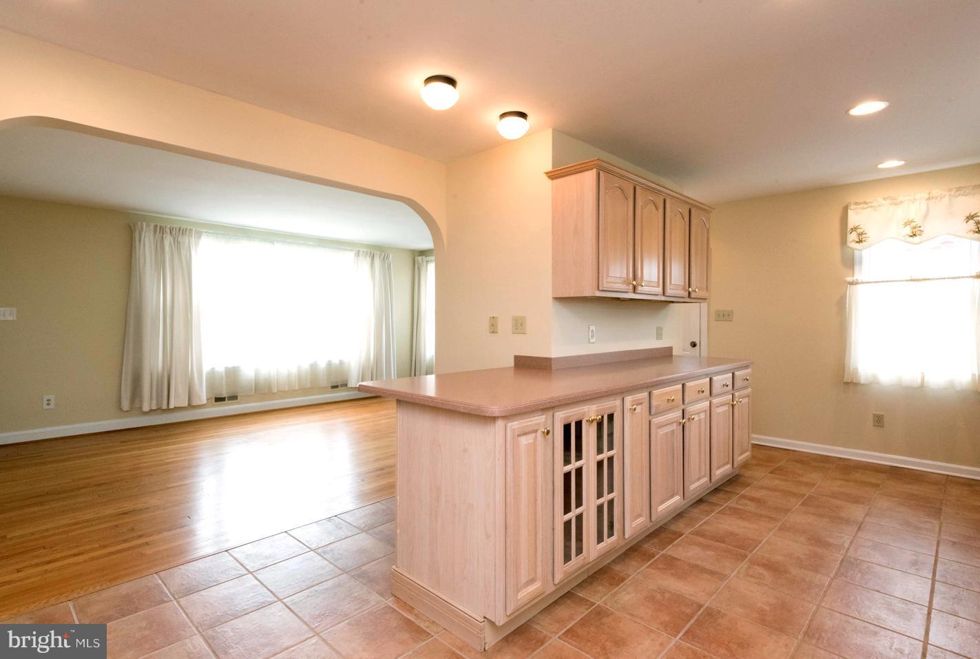 259 Harlem Road Pasadena, MD 21122 - Photo 11 of 30 Seamless Flow into Tile-Floored Chef's Kitchen