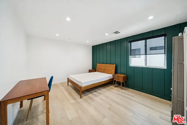 a living room with furniture a window and wooden floor