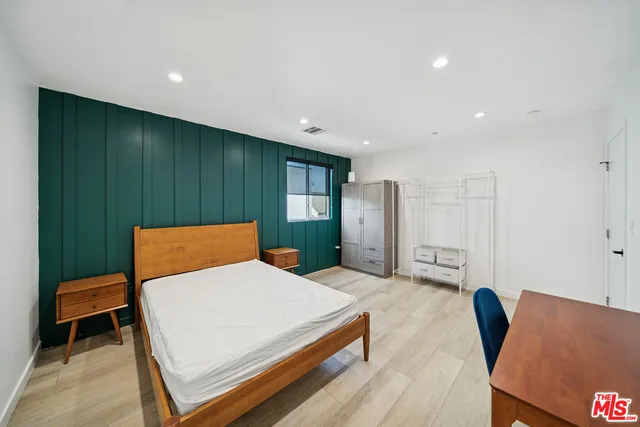 a bedroom with a bed and a chair