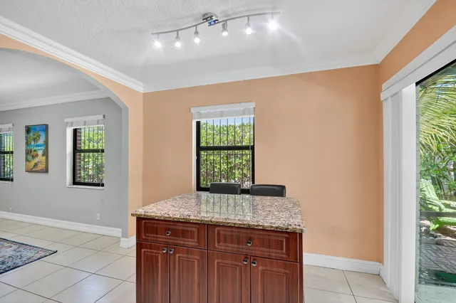 a large kitchen with granite countertop a stove a sink dishwasher and a refrigerator