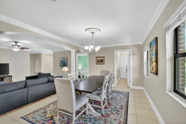 a view of a dining room with furniture and a chandelier