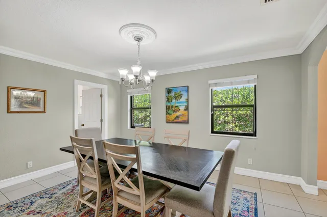a view of a dining room with furniture and a chandelier