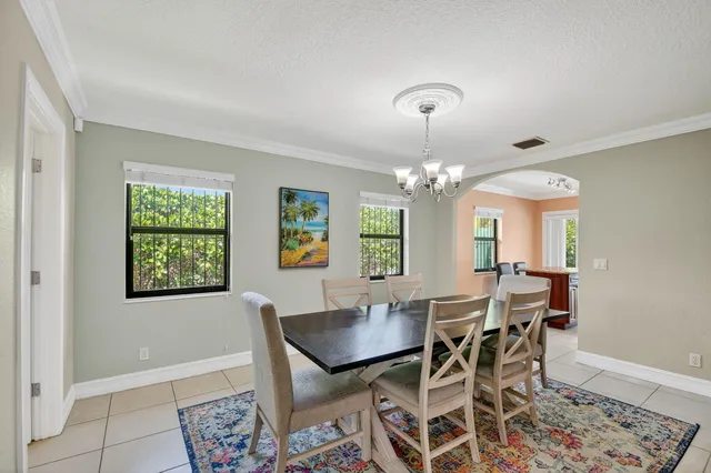 a living room with furniture chandelier and a flat screen tv