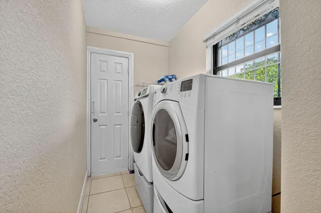 a bedroom with a large bed and a flat tv screen