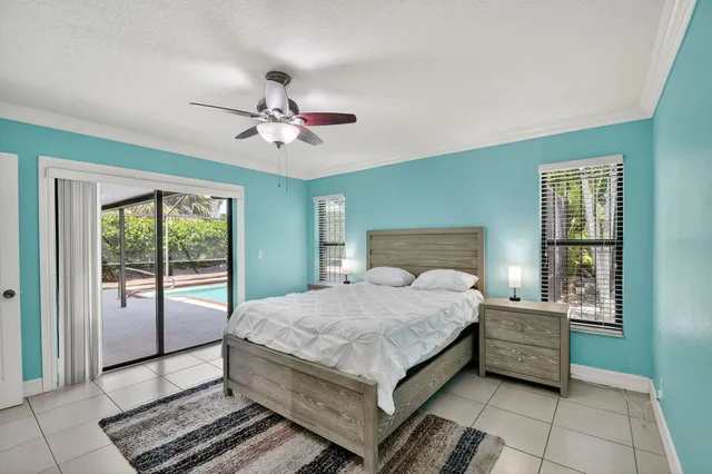 a bathroom with a toilet a sink and glass door shower