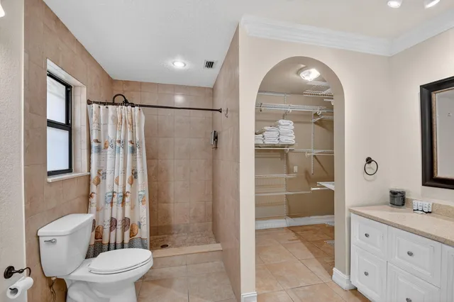 a bathroom with a double vanity sink and mirror with shower