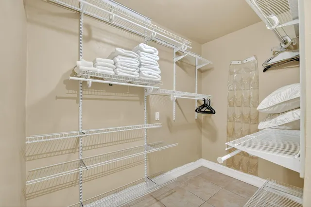 a room with a baby crib and dresser