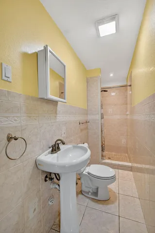 a bedroom with a bed a painting on the wall and a window