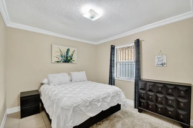 a bedroom with a bed and a television