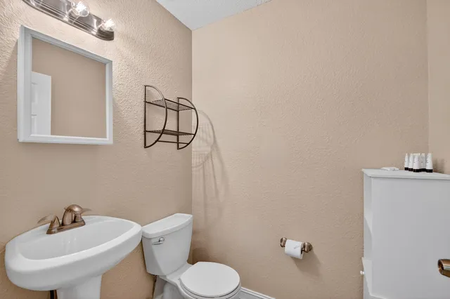 a living room with furniture a flat screen tv and a large window