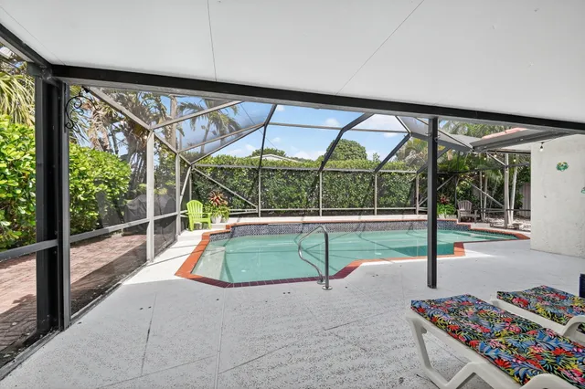 a living room with furniture and large windows