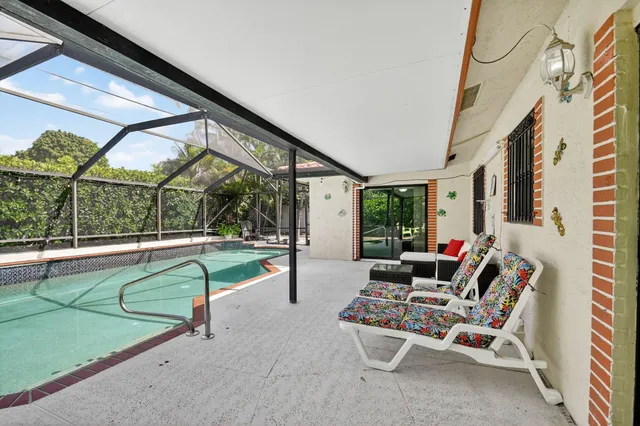 a view of a backyard with a patio and couches chairs