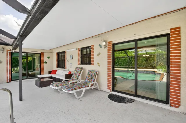 a view of a house with swimming pool and sitting area