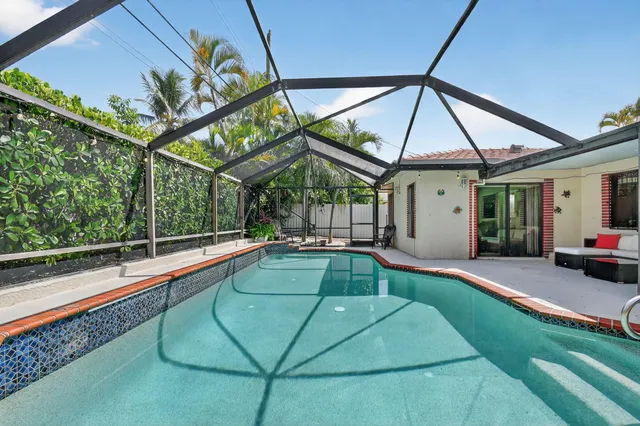 a view of swimming pool with a patio and a yard