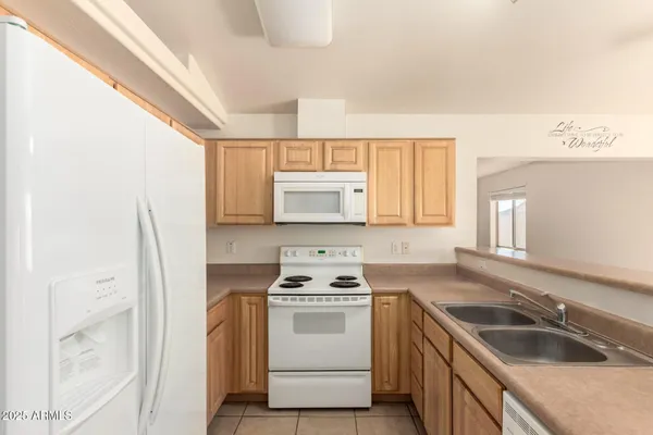 a kitchen with a stove sink and a refrigerator