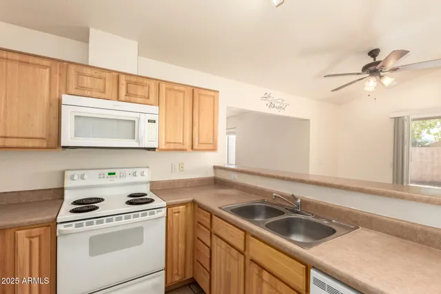 a kitchen with a sink stove top oven and cabinets
