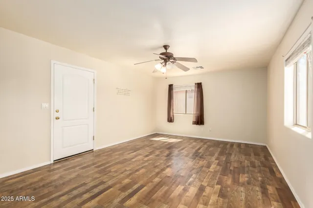 wooden floor in an empty room with a window