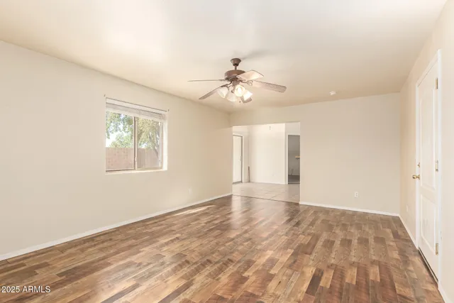 wooden floor in an empty room with a window