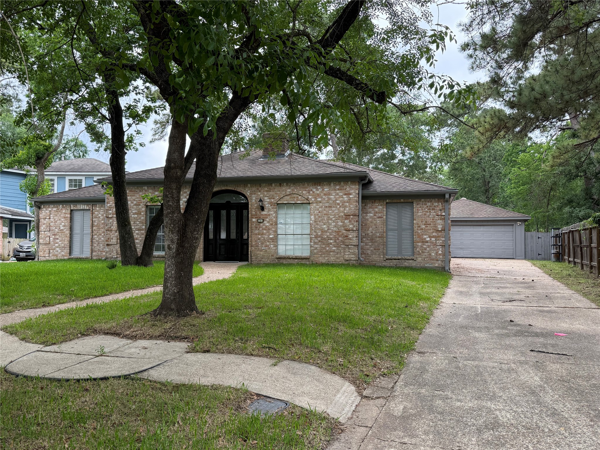 1847 Spruce Knob Drive Houston, TX 77339 - Photo 2 of 26 a front view of a house with a garden and trees