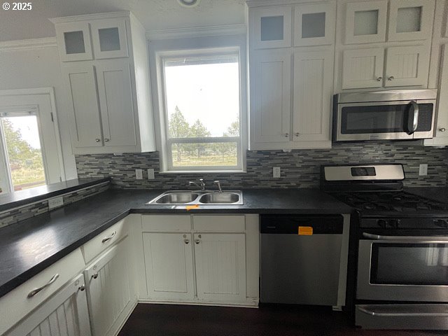 9290 Southwest 3115th Road Culver, OR 97734 - Photo 6 of 21 a kitchen with stainless steel appliances granite countertop a sink stove and microwave