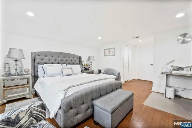 a bedroom with a bed and a chair