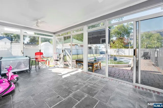 a living room filled with furniture and a floor to ceiling window