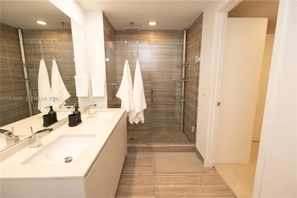 a bathroom with a double vanity sink and a shower